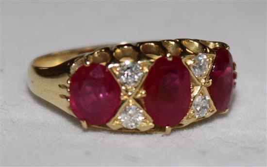 An 18ct gold, three stone ruby and four stone diamond ring, size N.